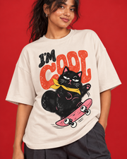 I'm Cool black skate cat graphic close-up terracotta typography yellow bandana pink skateboard on off-white tee
