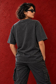 Plain back view of ONE MORE REP tee against red textured wall
