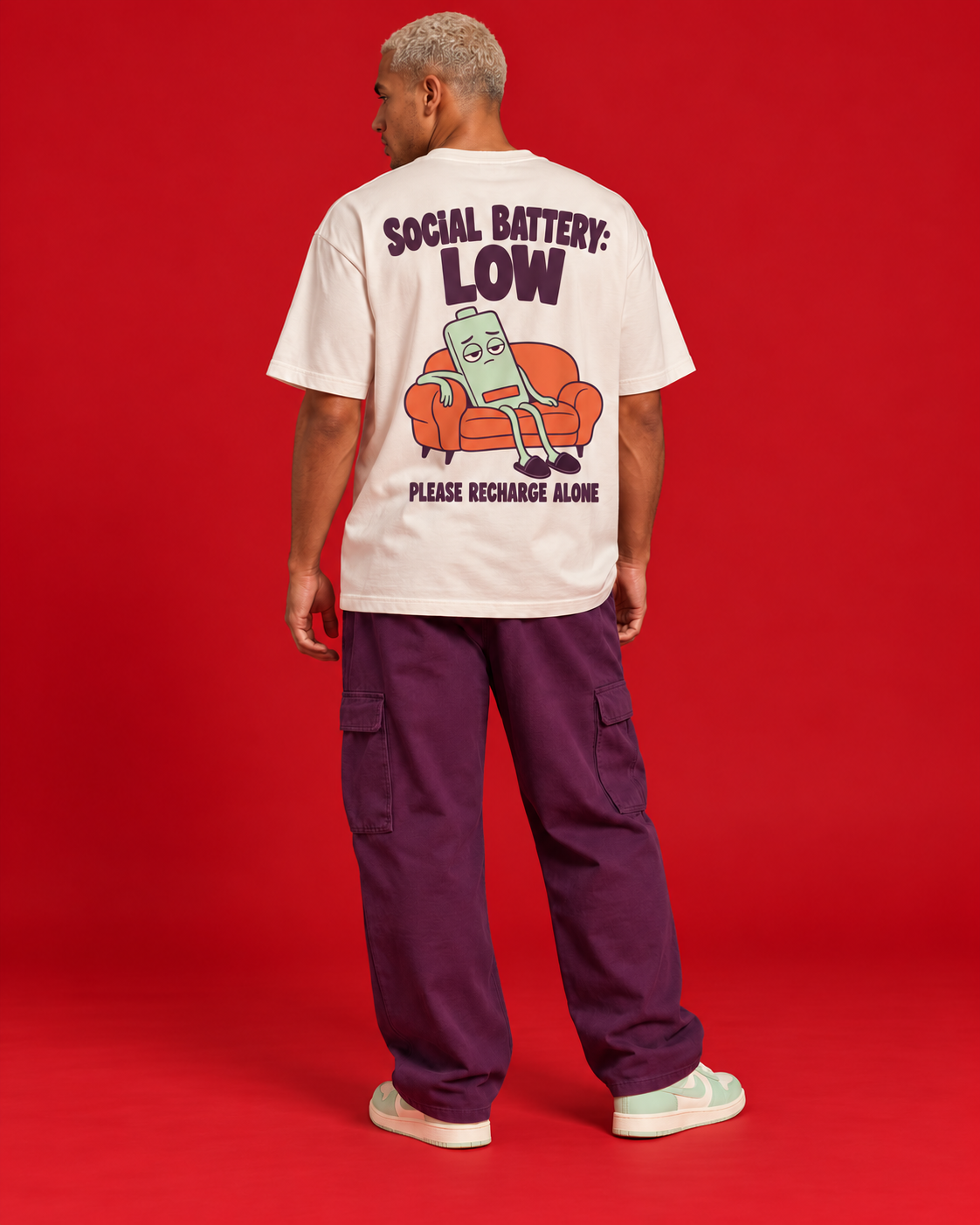 Social Battery Low off-white oversized T-shirt mint tired battery on coral sofa back graphic please recharge alone