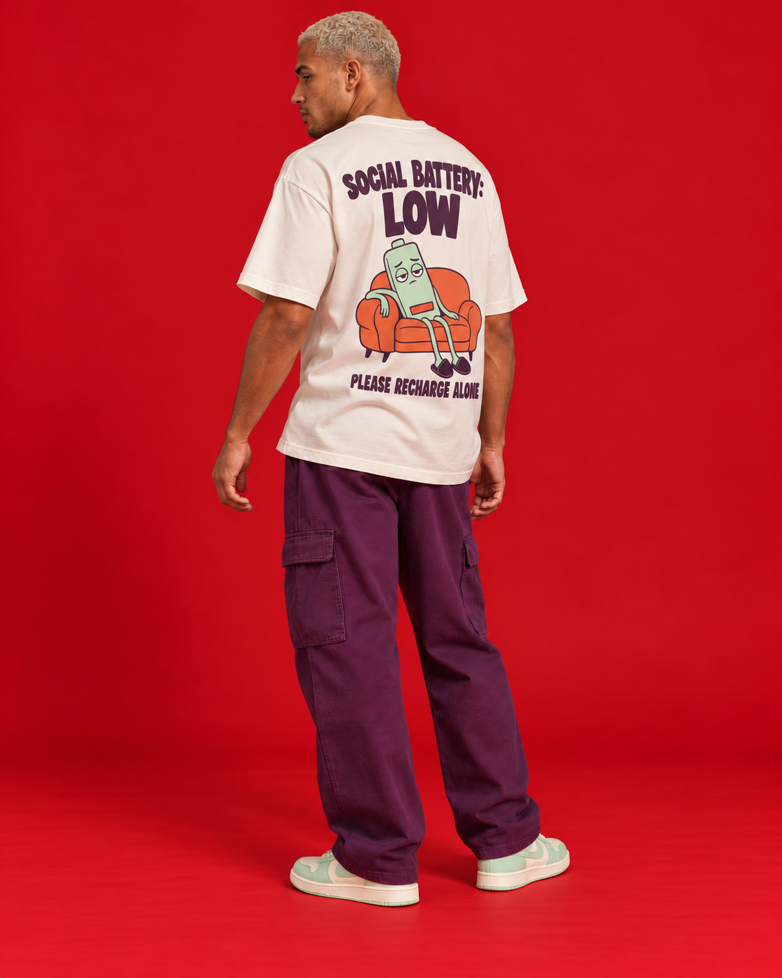 Social Battery Low off-white oversized T-shirt rear three-quarter view humorous battery sofa back print