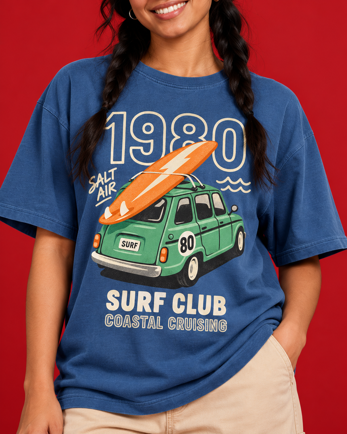 Surf Club 1980 green car orange surfboard cream typography close-up on women's blue cotton tee