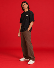 Tea Pour black oversized tee side view with compact left chest print