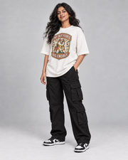 TINY BUT FIERCE WOMEN'S OVERSIZED T-SHIRT in Off White – three-quarter pose